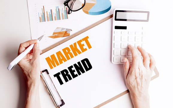 Market trend analysis with calculator, charts and hands reviewing financial data investment performance
