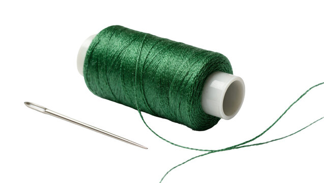 Green sewing thread spool with a silver metal needle and loose thread end