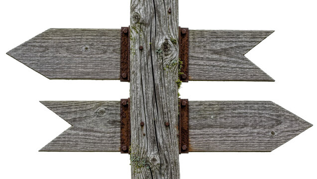 Weathered wooden directional signpost with two rustic arrow boards and rusty bolts