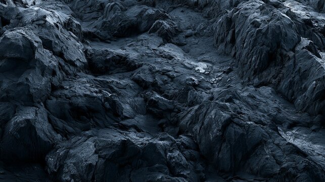 Dark textured basalt rock surface with rugged volcanic stone patterns and deep shadows in natural landscape
