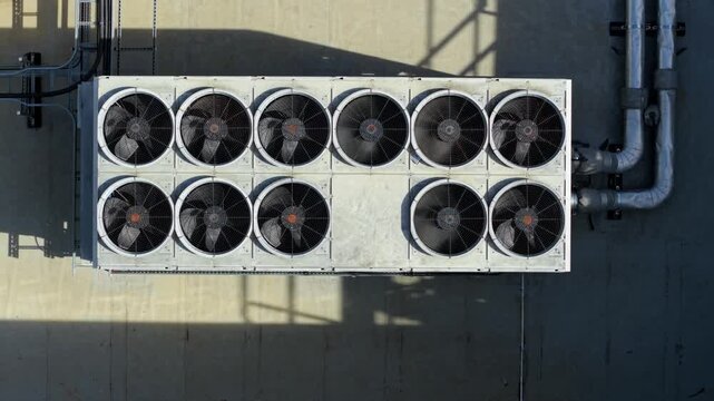 Top down close up aerial view of industrial HVAC ventilation unit with rotating fans in Luton, UK