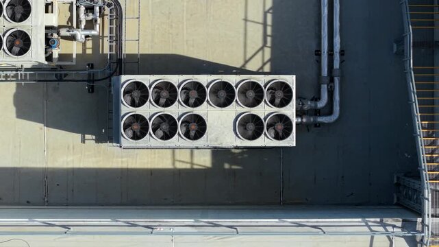 Top down close up aerial view of industrial HVAC ventilation unit with rotating fans in Luton, UK