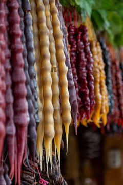 Colorful churchkhelas sweets hanging in rows, Tbilisi, Georgia