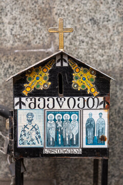 Orthodox donation box with saint icons and a golden cross, Tbilisi, Georgia