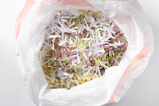 The word Important printed on a white piece of shredded paper in the middle of a bag full of paper shreds.