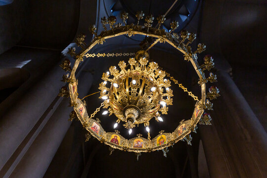 Gilded chandelier decorated with icons hanging inside the Metekhi Church, Tbilisi, Georgia
