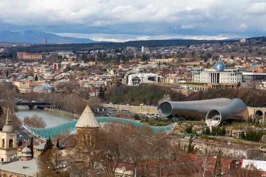 Aerial view of the Bridge of Peace over the Kura river and Rike Park, Tbilisi, Georgia