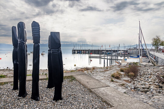 Wooden sculptures beside sailboat harbor on lake constance in arbon