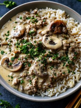 delicious homemade beef stroganoff with tender mushrooms and rich creamy gravy served over fluffy brown rice garnished with fresh chopped parsley comforting hearty meal gourmet dinner recipe
