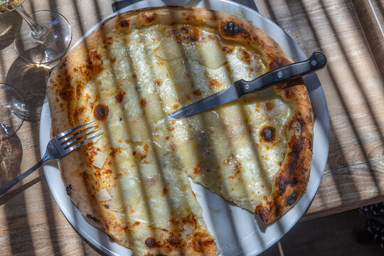 Delicious Pizza Served on a White Plate at a Cafe