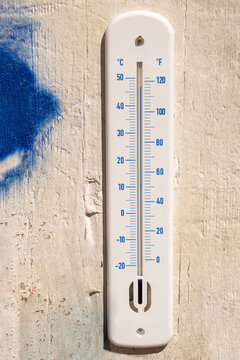 Thermometer Showing Temperature on a Wooden Wall