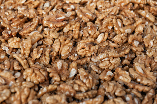 Shelled walnut kernel harvest background. Organic raw nut market pile