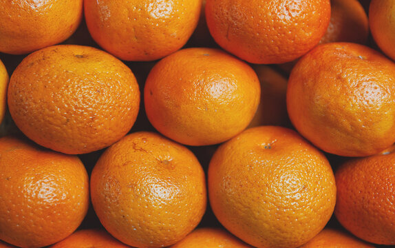 Fresh tangerine harvest background. Organic ripe mandarin fruit market pile