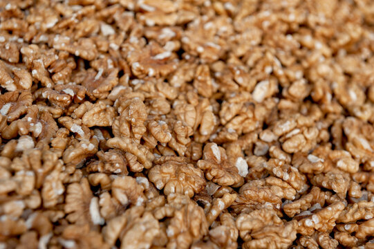Shelled walnut kernel harvest background. Organic raw nut market pile