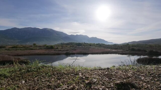 Passing a Vegetated Islet in a Reflecting Mountain Wetland