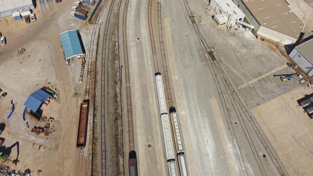 Drone aerial moving along railroad train freight tracks with rails along Chattanooga TN near choo choo downtown industrial vintage American Tennessee urban landscape