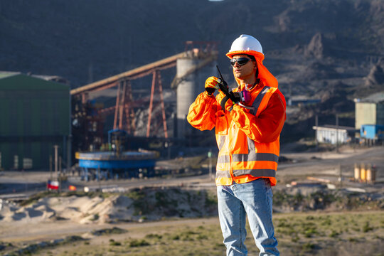 Mining worker communicating by radio, coordinating operations at an open-pit site