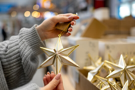Holding christmas star ornament inside store shopping