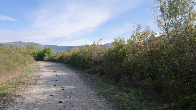 First-Person Scooter Ride Around a Gravel Trail Bend