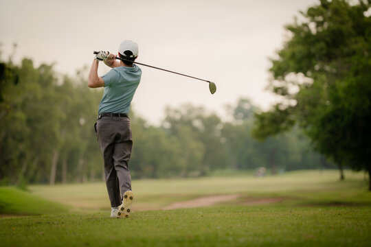 Professinal golf player on golf course. Pro golfer taking a shot. sport, golf, golfer, golfing, club,	