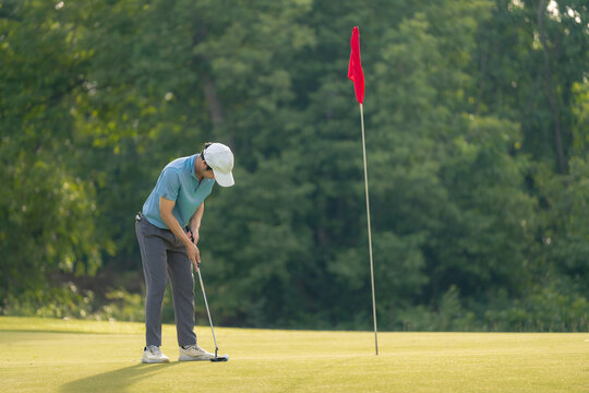 Professinal golf player on golf course. Pro golfer taking a shot. sport, golf, golfer, golfing, club,	