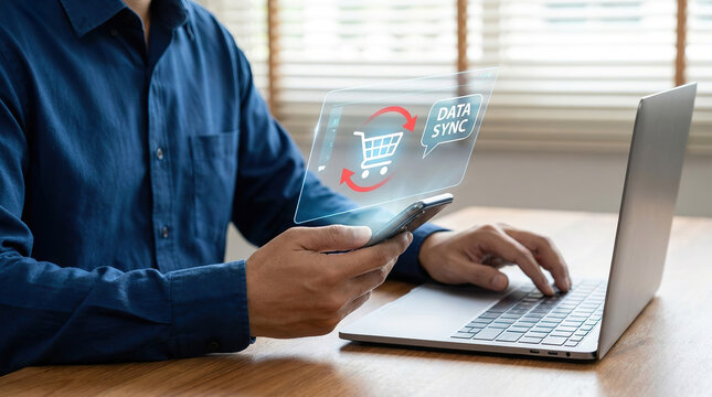 Man using a credit card to make an online purchase on a laptop at a bright home office desk