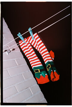 elf socks hang from an outdoor clothesline at night, 35mm film