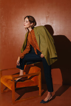 Elegant Woman in Brown Coat and Textured Dress