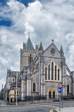 Historic facade of Christ Church Cathedral in Dublin, Ireland. Majestic medieval architecture stands out under a cloudy daylight sky
