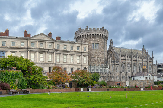 Scenic view of Dublin Castle from the garden in Ireland. Historic heritage architecture stands out under a cloudy daylight sky