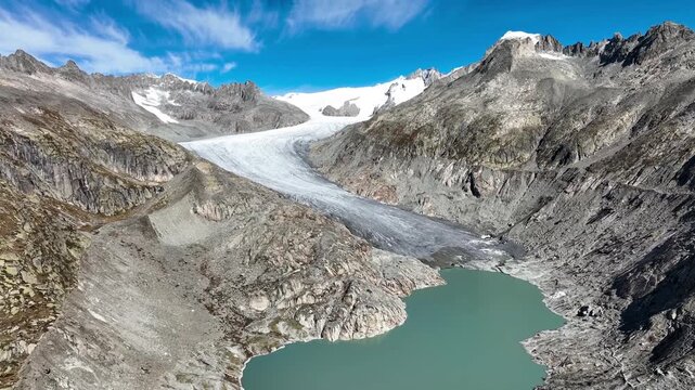 Scenic aerial drone footage of the retreating Rhone Glacier (Rhonegletscher) located near the winding Furka Pass road in Valais, Switzerland. Breathtaking landscape of the High Alps, showcasing dramat