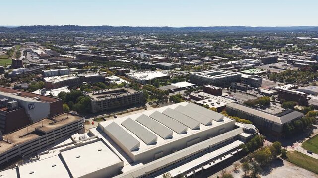 Drone aerial of downtown city of Chattanooga Tennessee in United States with roads, buildings, museums, and attractions along highway and with Choo Choo signage on top building rooftops in moving shot