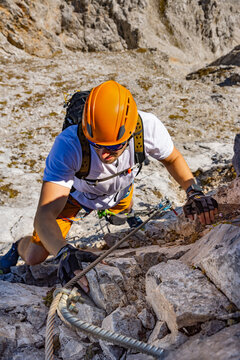 Via Ferrata Climber Ascending a Rocky Wall in the Alps