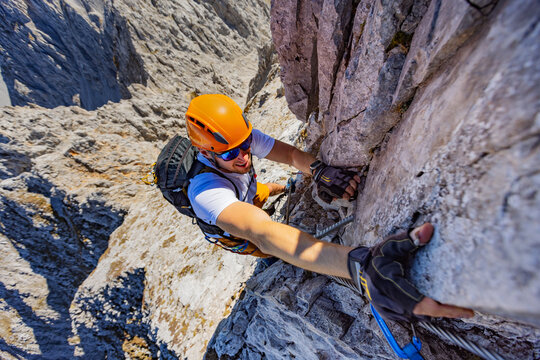 Via Ferrata Climber Ascending a Rocky Wall in the Alps