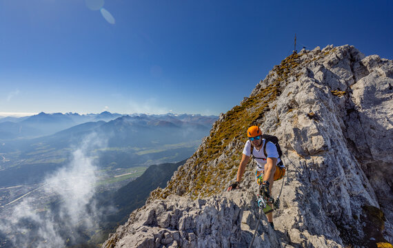 Via Ferrata Climber Ascending a Rocky Wall in the Alps