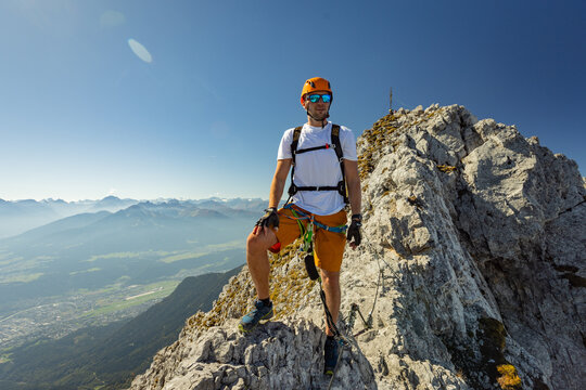Via Ferrata Climber Ascending a Rocky Wall in the Alps