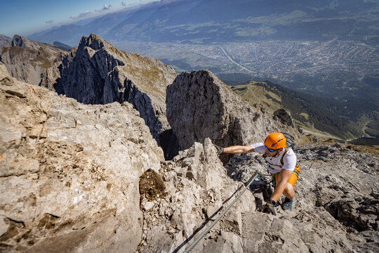 Via Ferrata Climber Ascending a Rocky Wall in the Alps
