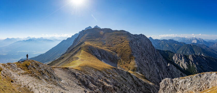 Panoramic Alpine Mountain Peaks with a Climber on a Via Ferrata