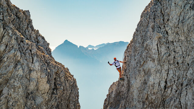 Via Ferrata Climber Ascending a Rocky Wall in the Alps