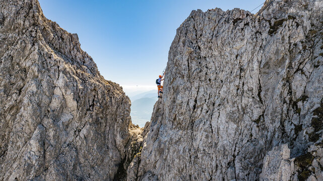 Via Ferrata Climber Ascending a Rocky Wall in the Alps