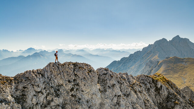 Panoramic Alpine Mountain Peaks with a Climber on a Via Ferrata