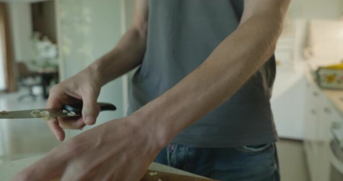 Close-up male hands peel boiled potato with knife. 4K 10-bit