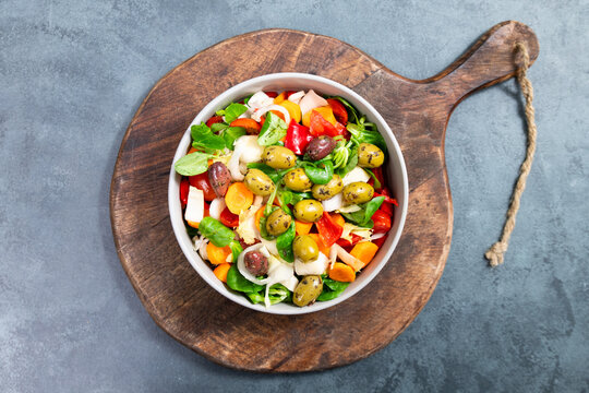 Salad bowl with lettuce, chicory, olives, cucumber, spinach, tomatoes and herbs, healthy mediterranean food, homemade meal, lifestyle and nutrition diet