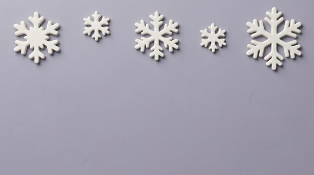 A serene and magical christmas backdrop featuring delicate white snowflakes against a soft muted gray evoking winter's peaceful beauty and festive cheer