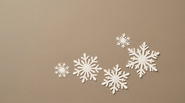 A serene and elegant christmas background featuring delicate white snowflakes against a soft warm neutral beige and brown gradient backdrop