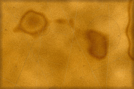 Vintage yellowed parchment paper background texture featuring dark coffee stains scratches and worn aged paper edges for historical design projects