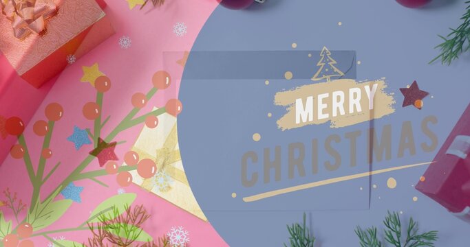 Displaying rectangular greeting card bearing MERRY CHRISTMAS on flat craft surface