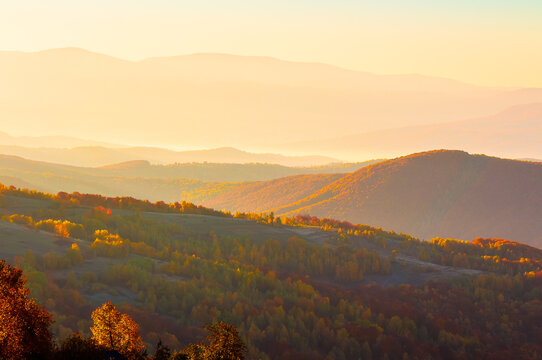 gorgeous foggy sunrise in Carpathian mountains. lovely autumn landscape of Perechyn district. valley and forested hill in fog and morning light. mountain ridge in the distance