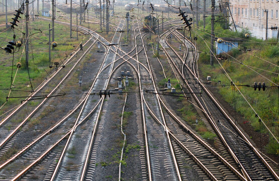 Elevated view of complex railway tracks, switches, and overhead power lines at the Darnytsia sorting station in Kyiv, Ukraine