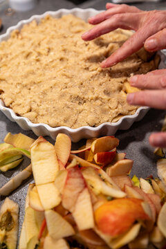 Stockholm, Sweden A cook in a residential kitchen puts the final touches on the crust of an upside-down apple pie with her fingers.